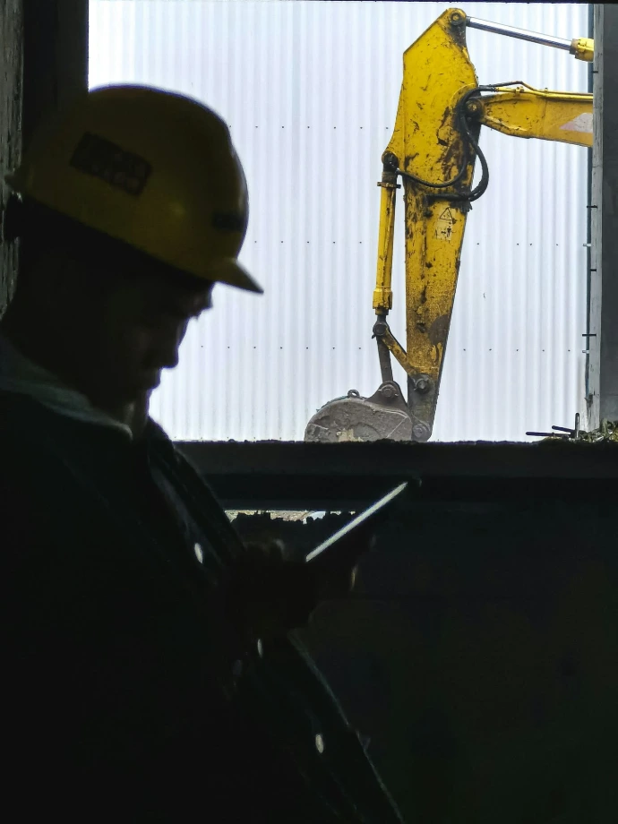 a man wearing a hard hat working on a machine